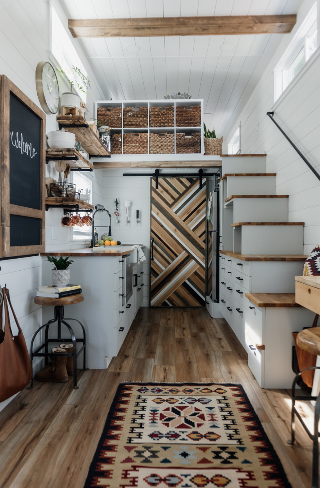 Tiny home interior looking down from the sleeping loft